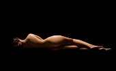 Portait of nude woman lying on her side