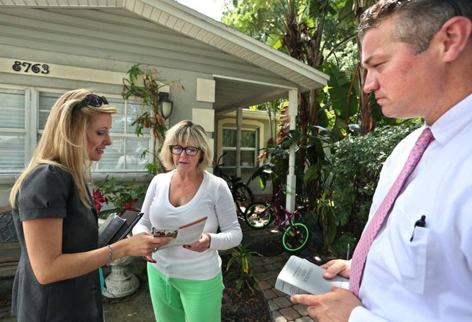 Jehovah’s Witnesses Mary and Jonathan Burns share Bible verses and literature with Pinellas Park resident Leslie Pevey, center. The Burns have visited Pevey several times over the past six months.