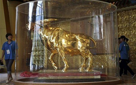 The 1-ton 24K gold bull sculpture unveiled in the newly completed 328-meter-tall New Village Building in Huaxi village in Jiangyin city in eastern China's Jiangsu province