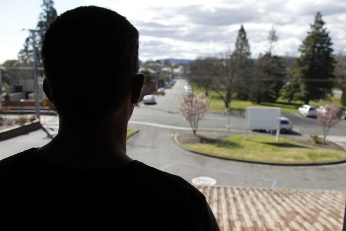 A man looking out a window