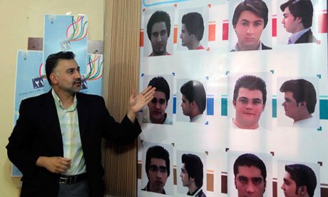 An official describes appropriate hairstyles for men at an  official hairstyle show in Tehran