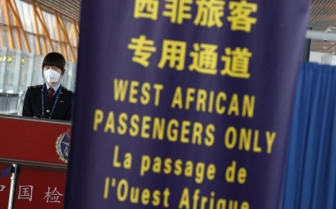 A quarantine official stands at a lane reserved for nationals from West African countries hit by the Ebola virus, at Beijing Capital International Airport. Photo: Reuters