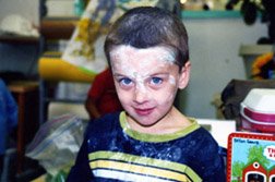 Photo of boy with white dirt on his face