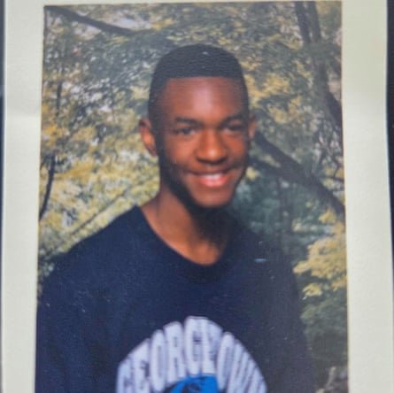 A boy smiles in a T-shirt that says ‘Georgetown’