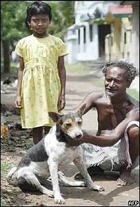 An Indian villager poses with his dog and Karnamoni Ha