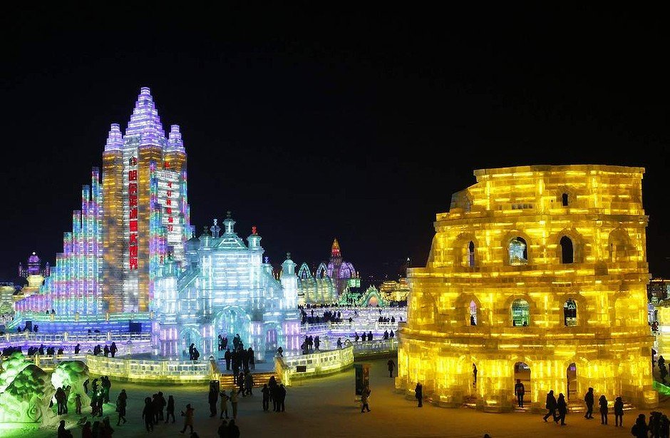 Visitors look at ice sculptures during a light-up rehearsal ahead of the Harbin Ice and Snow Sculpture Festival.