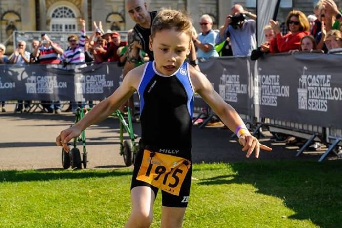 Bailey Matthews, 8, crosses the finish line at the Castle Howard Triathlon.