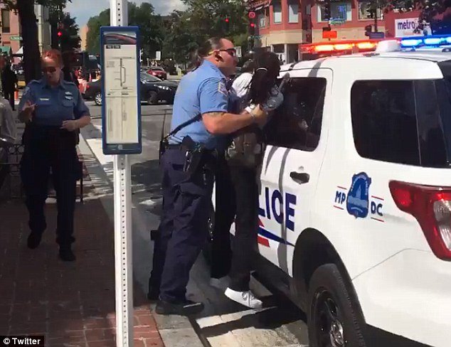 Grabbed: Footage from Twitter shows a small black Washington, DC woman, identified only as 'Shadon' being held up roughly against a police cruiser by her arms